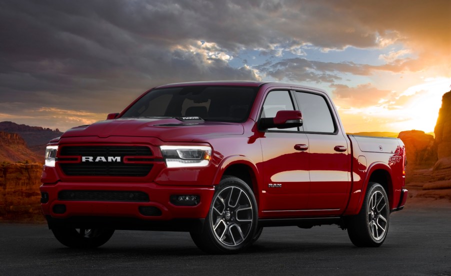 Promo shot of a red Ram 1500 Laramie G/T muscle truck parked in front of a sunset in the desert.