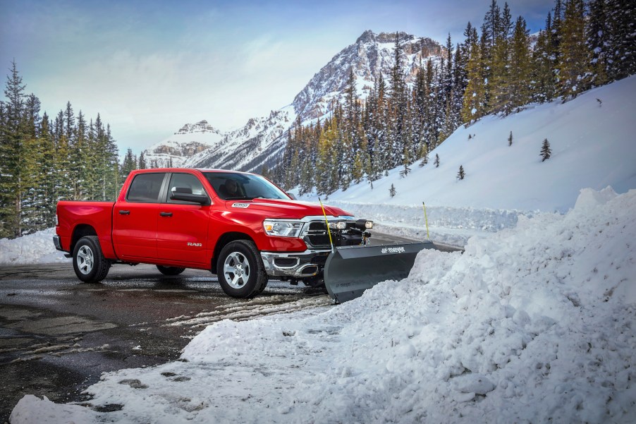 A red 2022 Ram 1500 in front of snow.