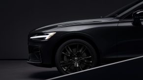 A close-up look at a black 2022 Volvo S60 Black Edition's front wheel