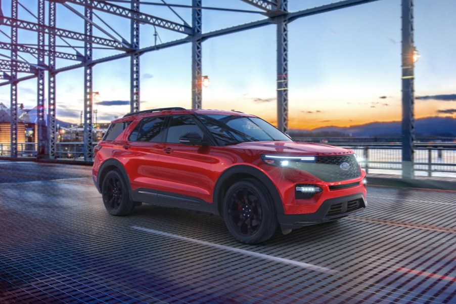 A red 2022 Ford Explorer driving on a bridge.