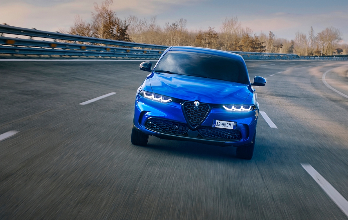 A bright-blue 2023 Alfa Romeo Tonale Veloce PHEV on a racetrack