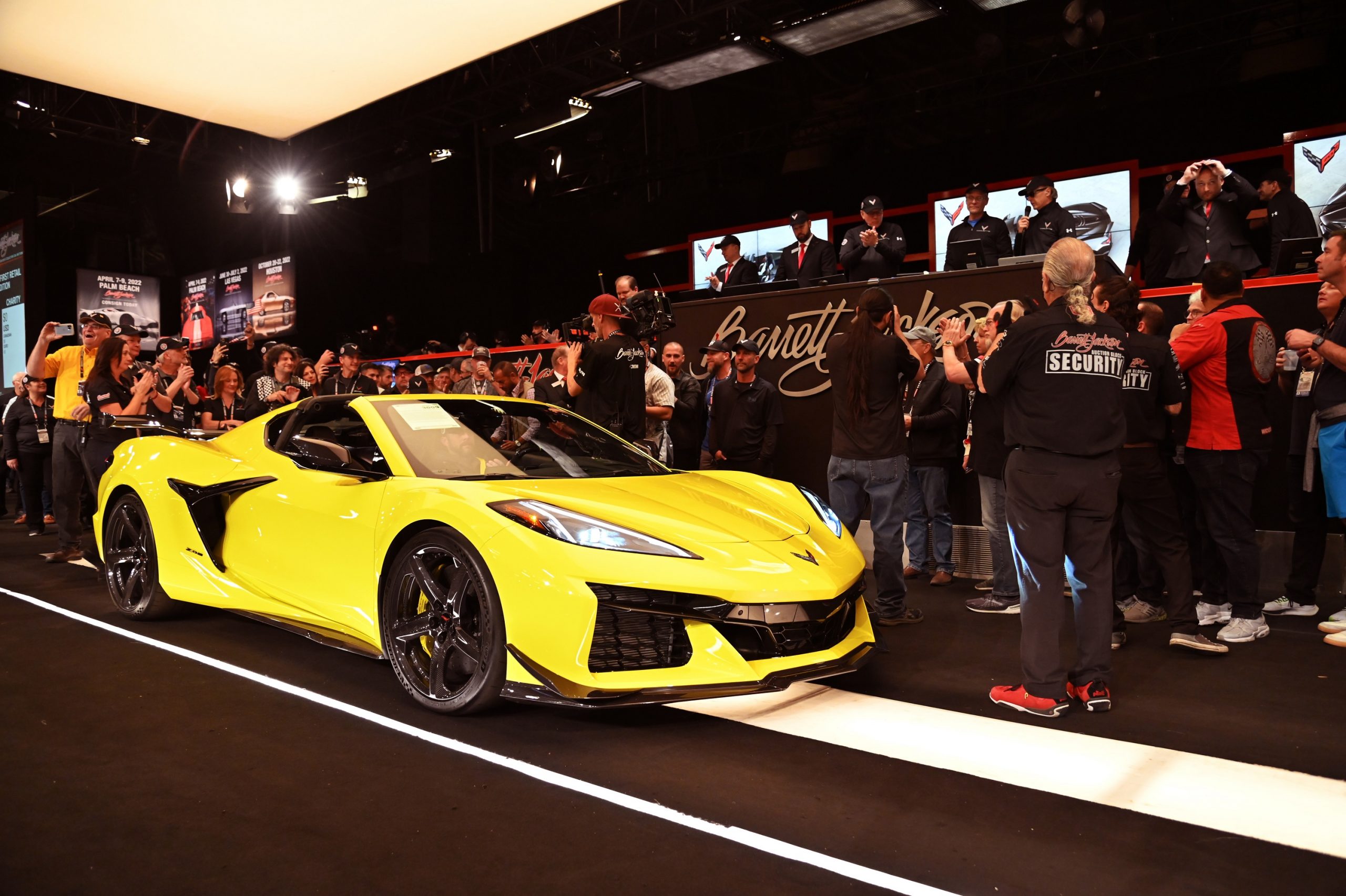 A yellow Corvette Z06 on the auction block at Barrett-Jackson