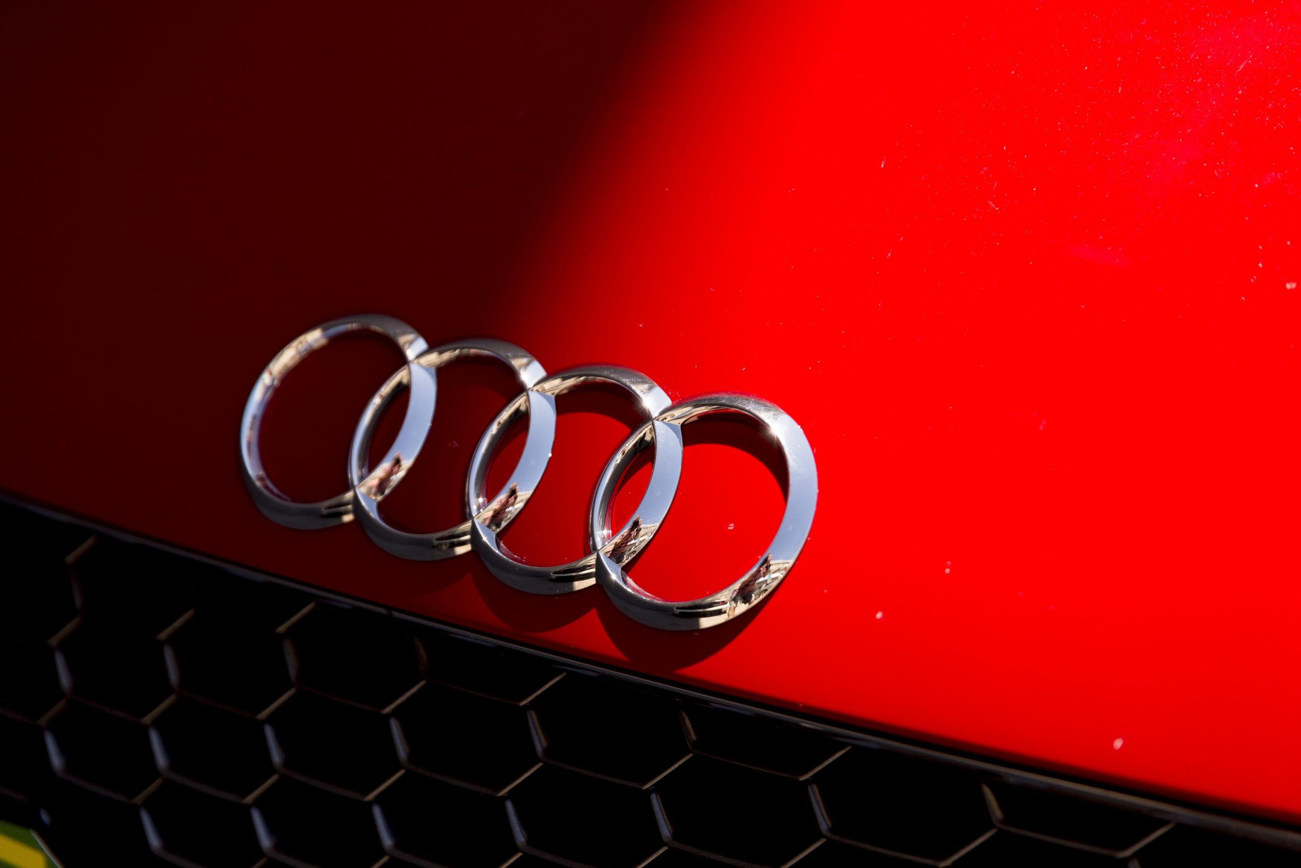 Audi's four rings logo on the hood of one of its cars