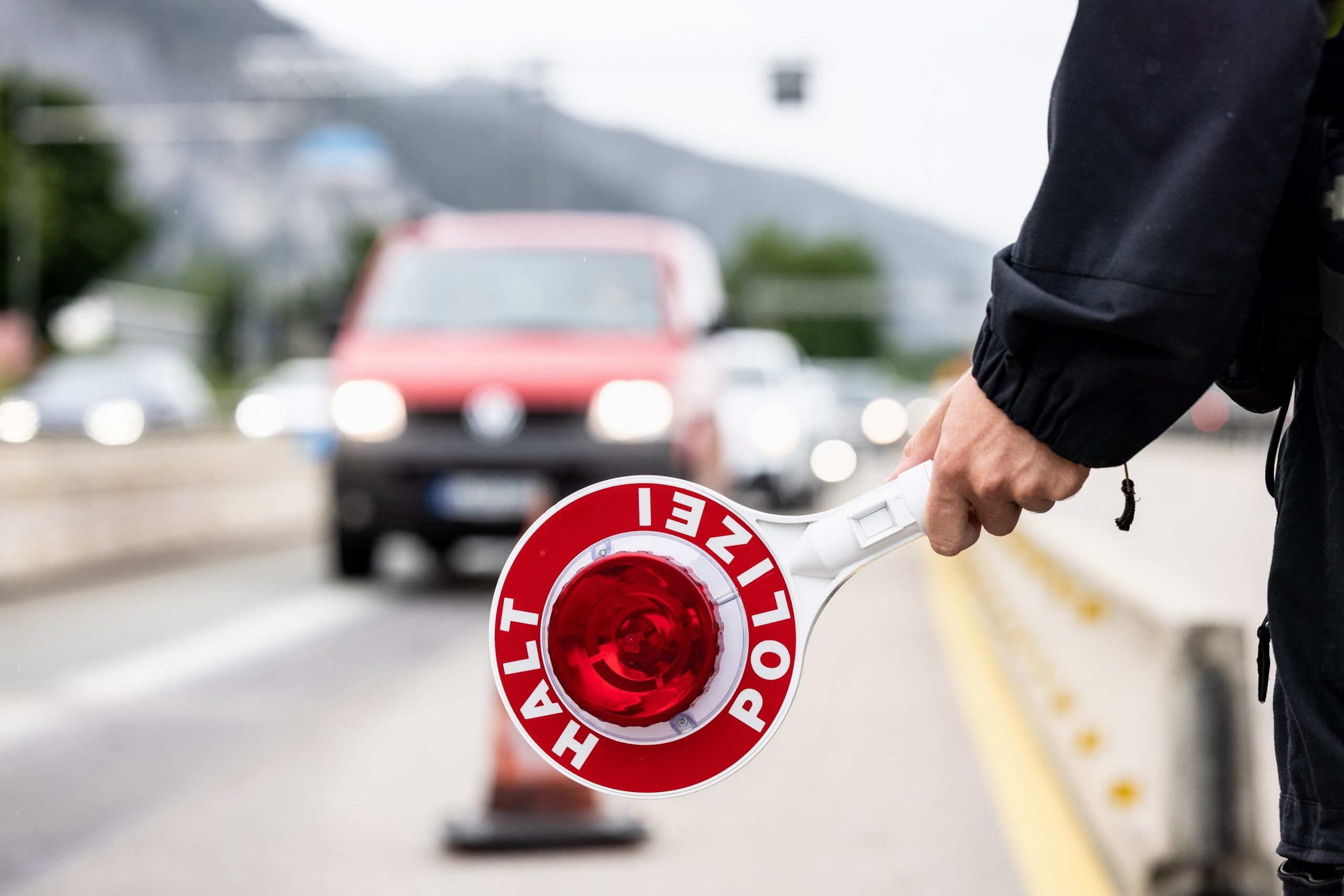 A German Polizei unit holds out a stop sign on the Autobahn