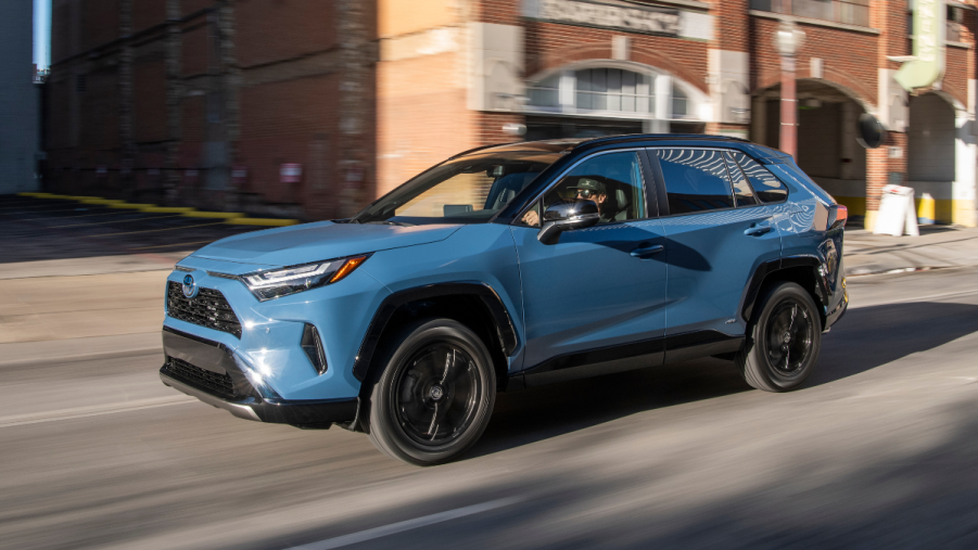 Blue 2022 Toyota RAV4 driving on a city street