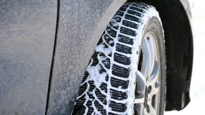 A car tire with snow between the treads