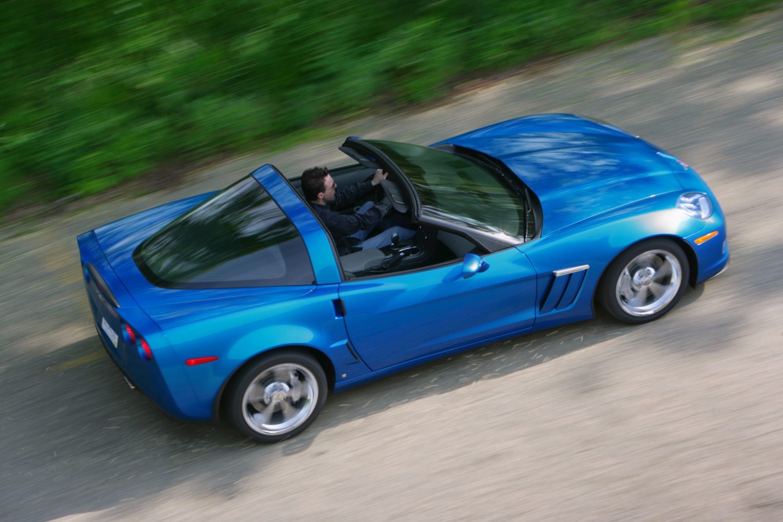 A blue Chevrolet Corvette convertible sports car shot from above