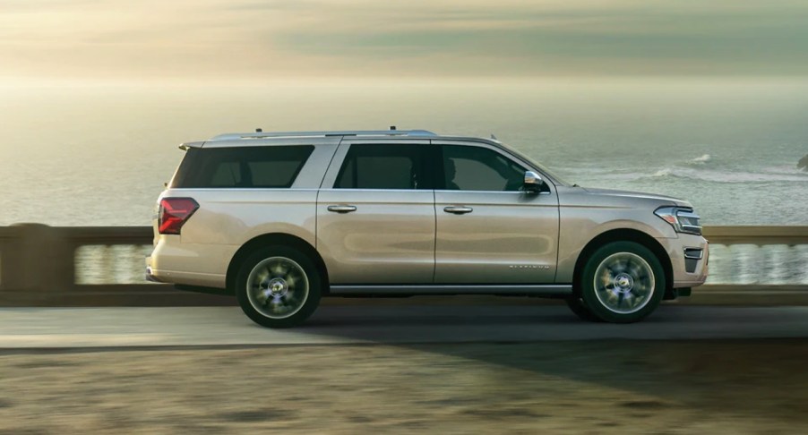 A beige 2022 Ford Expedition parked in front of a setting sun.