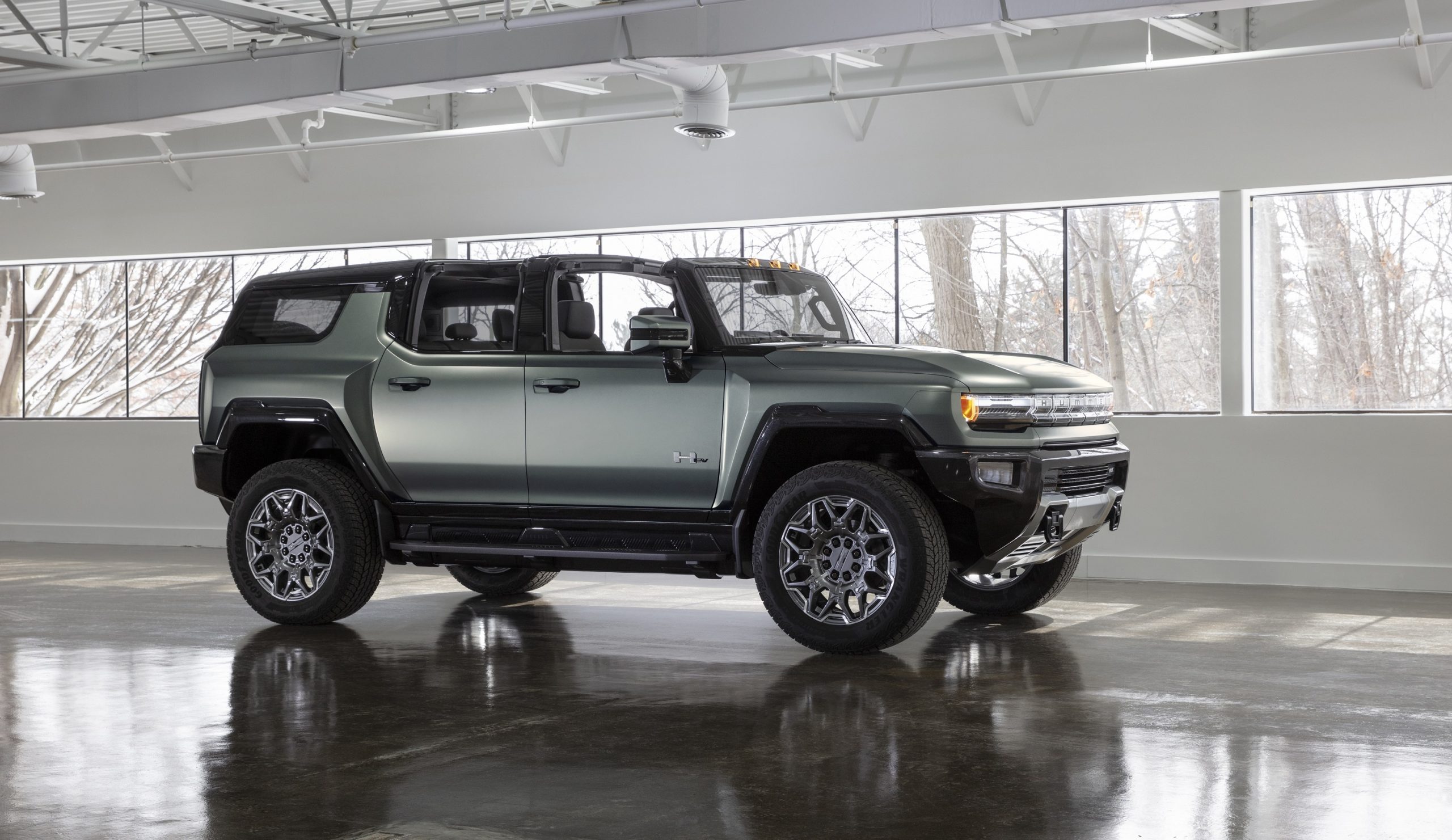 A grey GMC HUMMER EV shot in profile in a parking garage