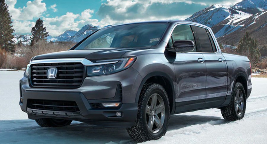 A gray 2022 Honda Ridgeline is parked in the snow.