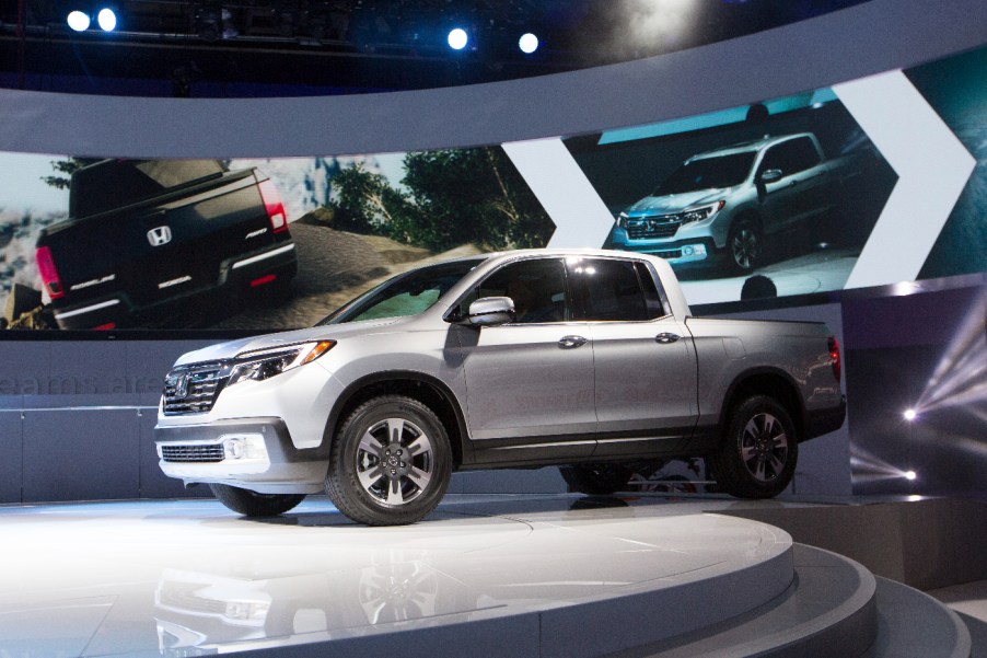 A Honda Ridgeline truck featured at an auto show.