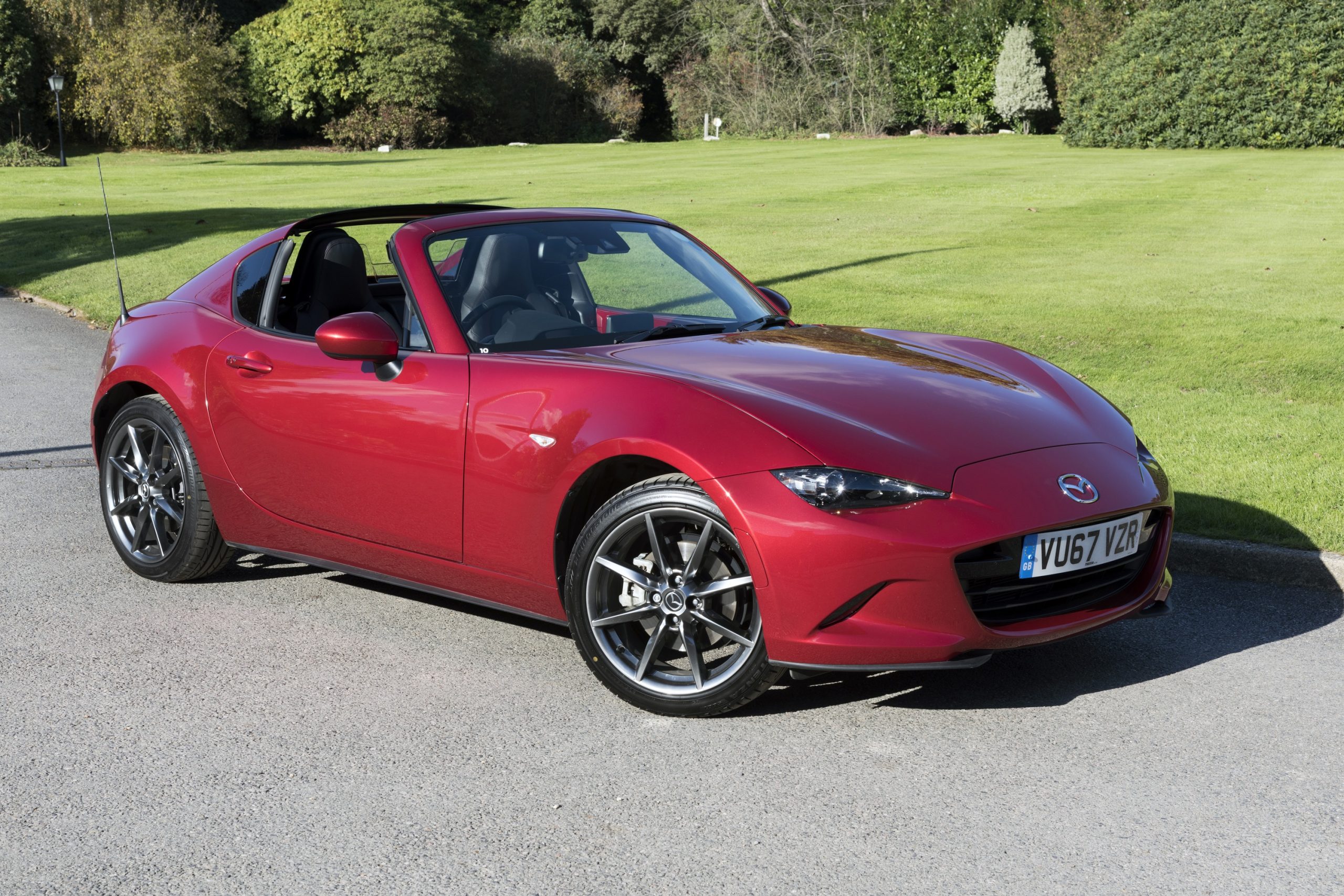 A red Mazda Miata sports car shot from the front 3/4