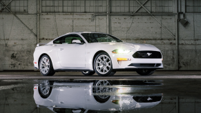 Passenger's side front angle view of white 2022 Ford Mustang, highlighting release date and price of 2023 Ford Mustang