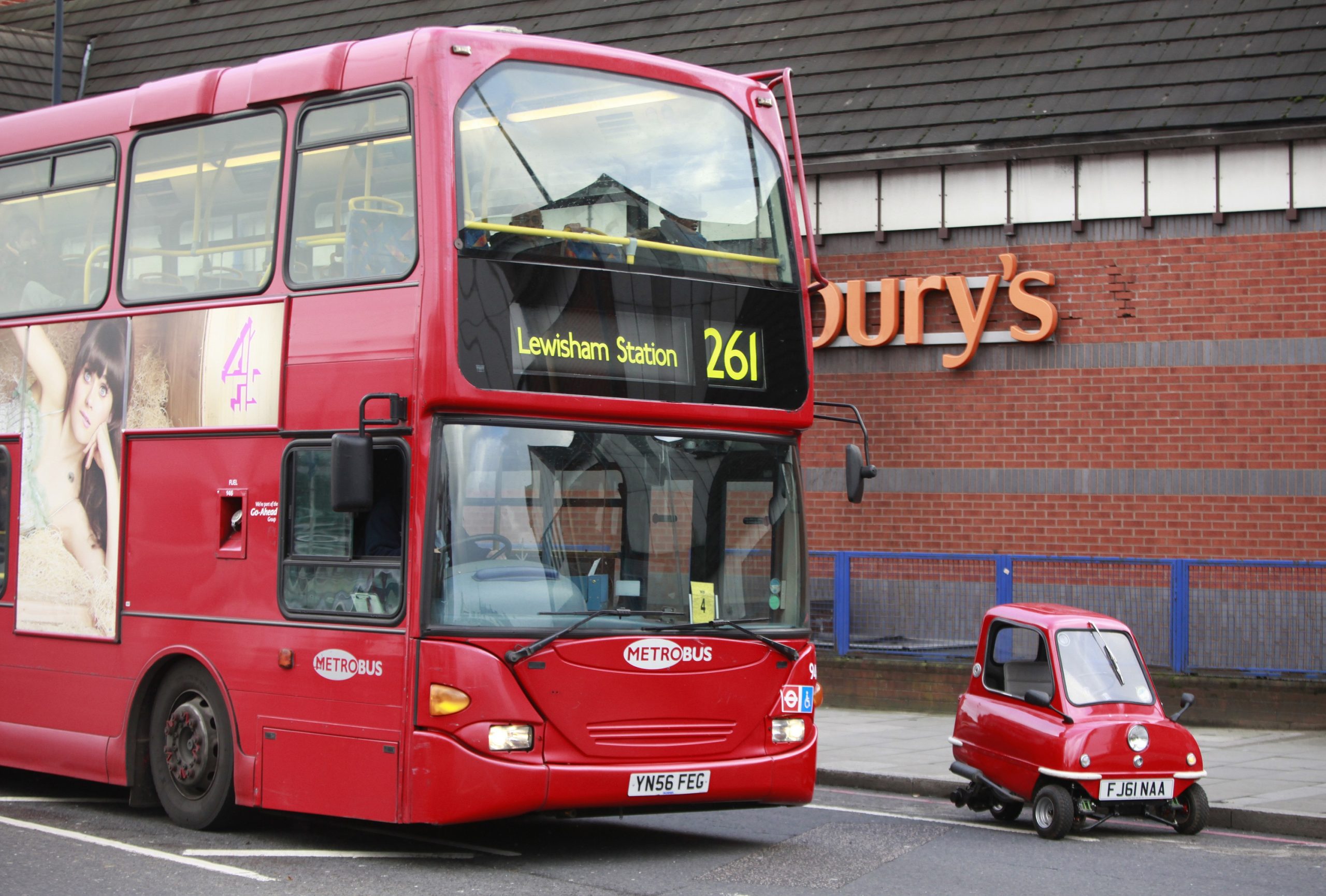 The Peel P50, the world's smallest production car, pictured next to a London double-decker bus