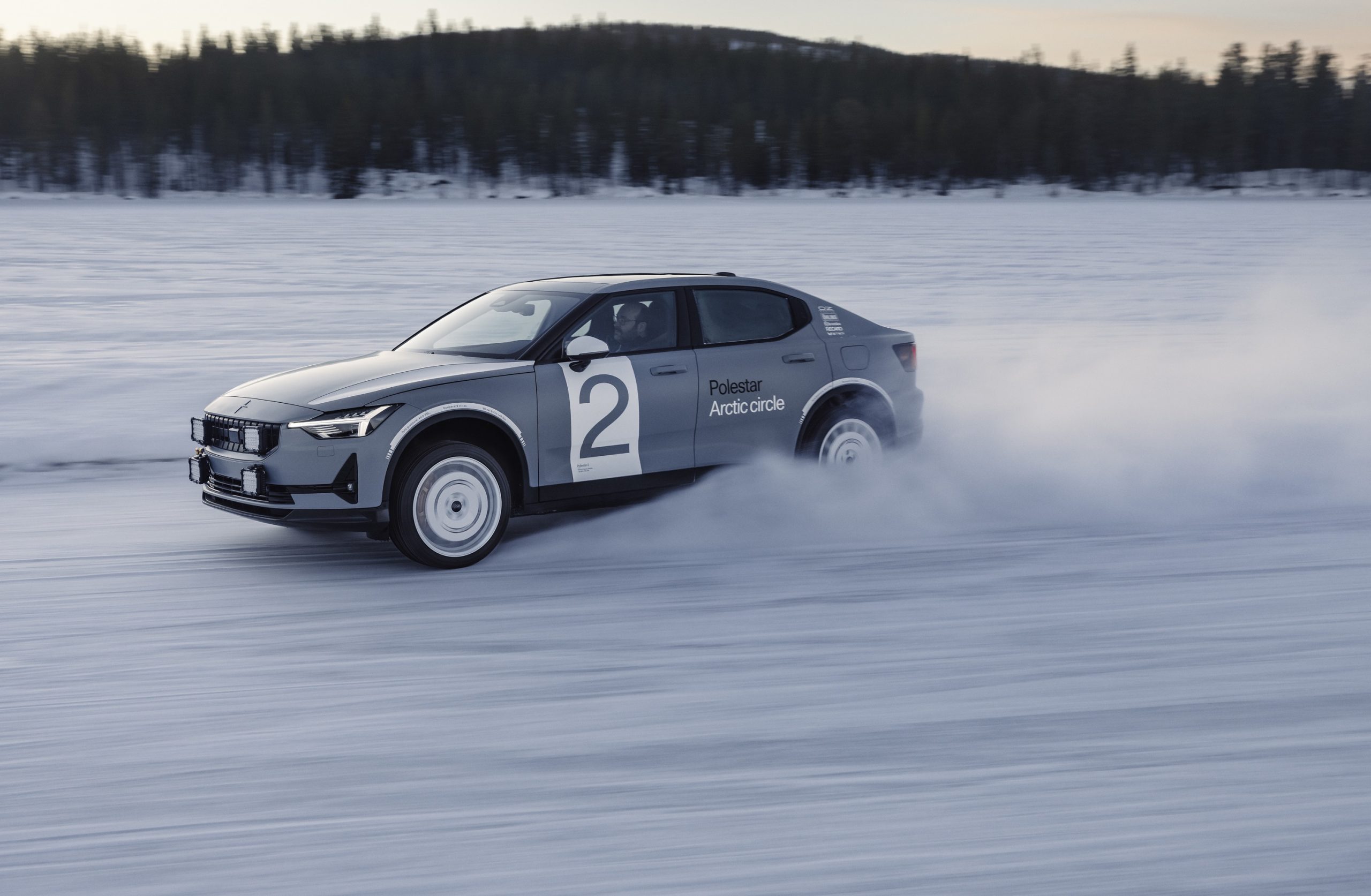 A Polestar 2 shot in profile mid-drift