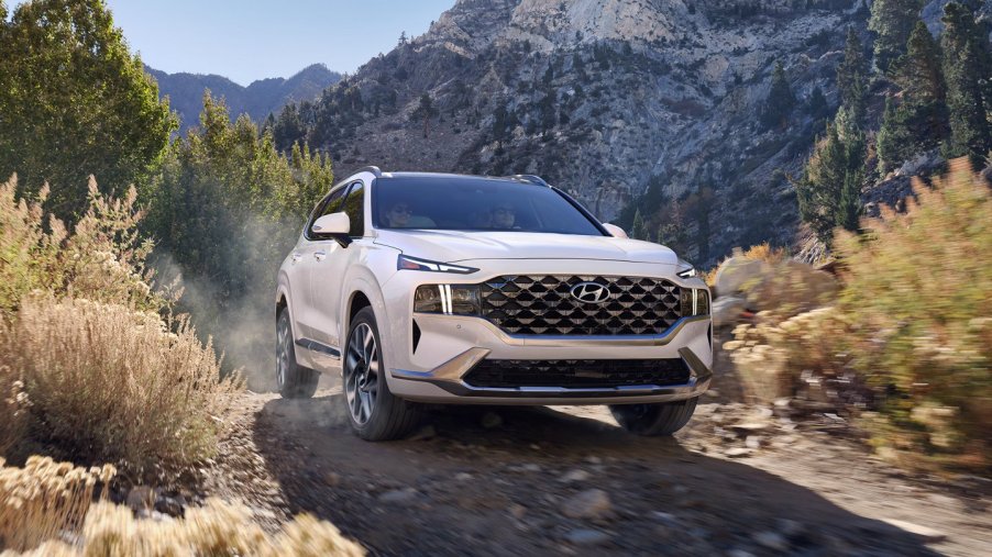 Quartz White 2022 Hyundai Santa Fe driving on moutainous terrain