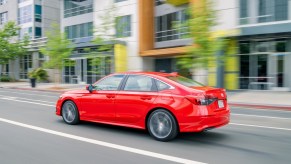 Red 2022 Honda Civic driving on a street, highlighting the cars Democrats and Republicans drive the most