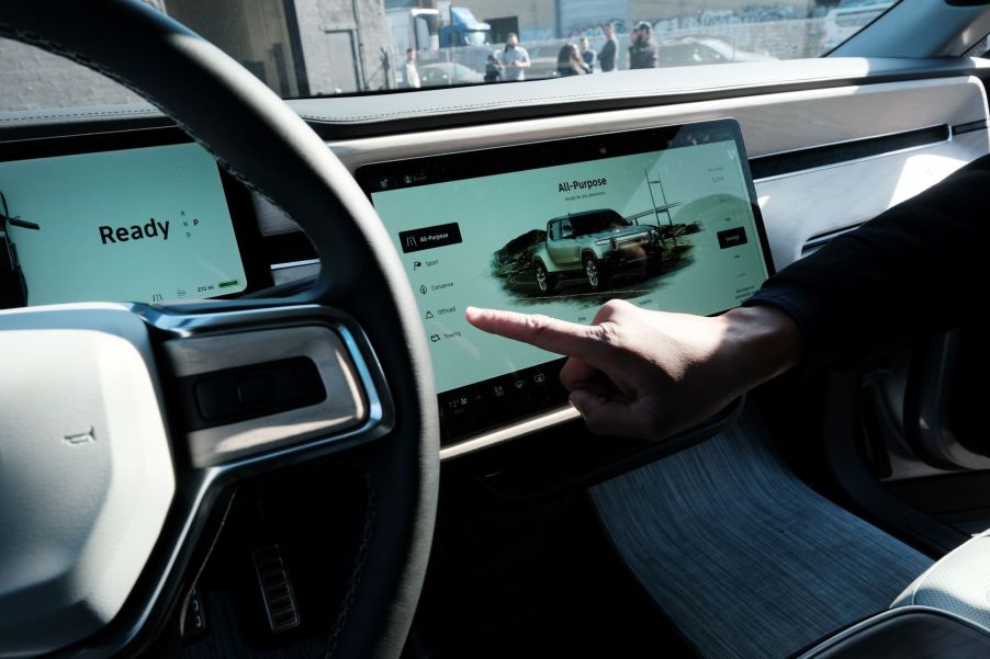 The interior of the Rivian R1T electric pickup truck where Gear Guard can be activated and used on the touchscreen