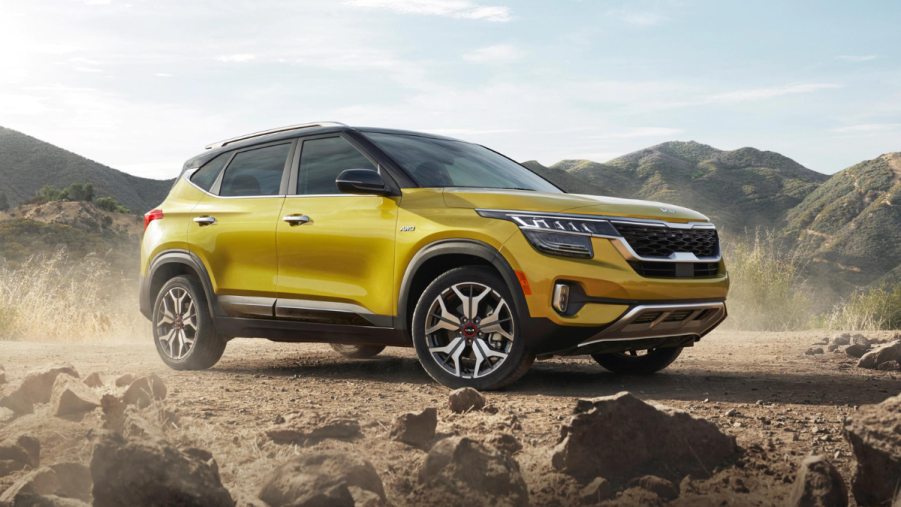 Starbright Yellow 2022 Kia Seltos parked next to some rocks