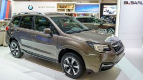 A beige Subaru Forester parked indoors.