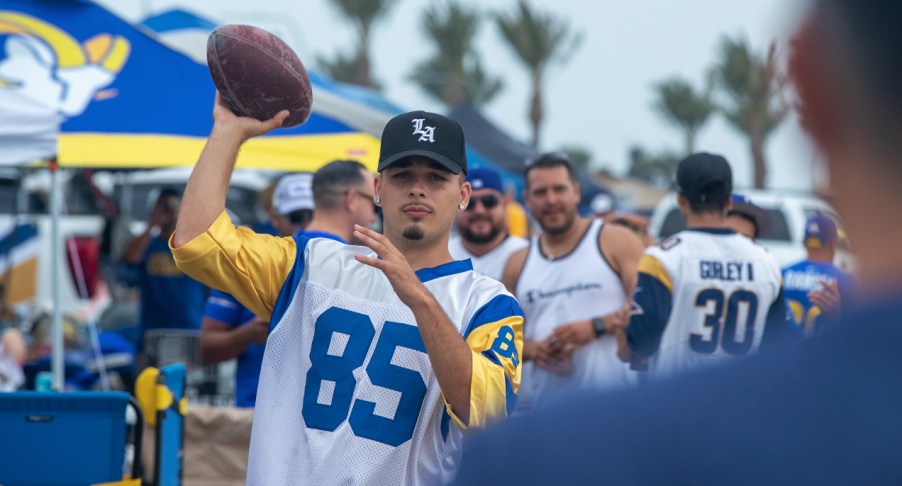 Man throwing ball at a tailgate party.