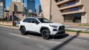 Super White 2022 Toyota RAV4 driving on a city street