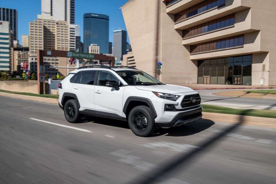 Super White 2022 Toyota RAV4 driving on a city street