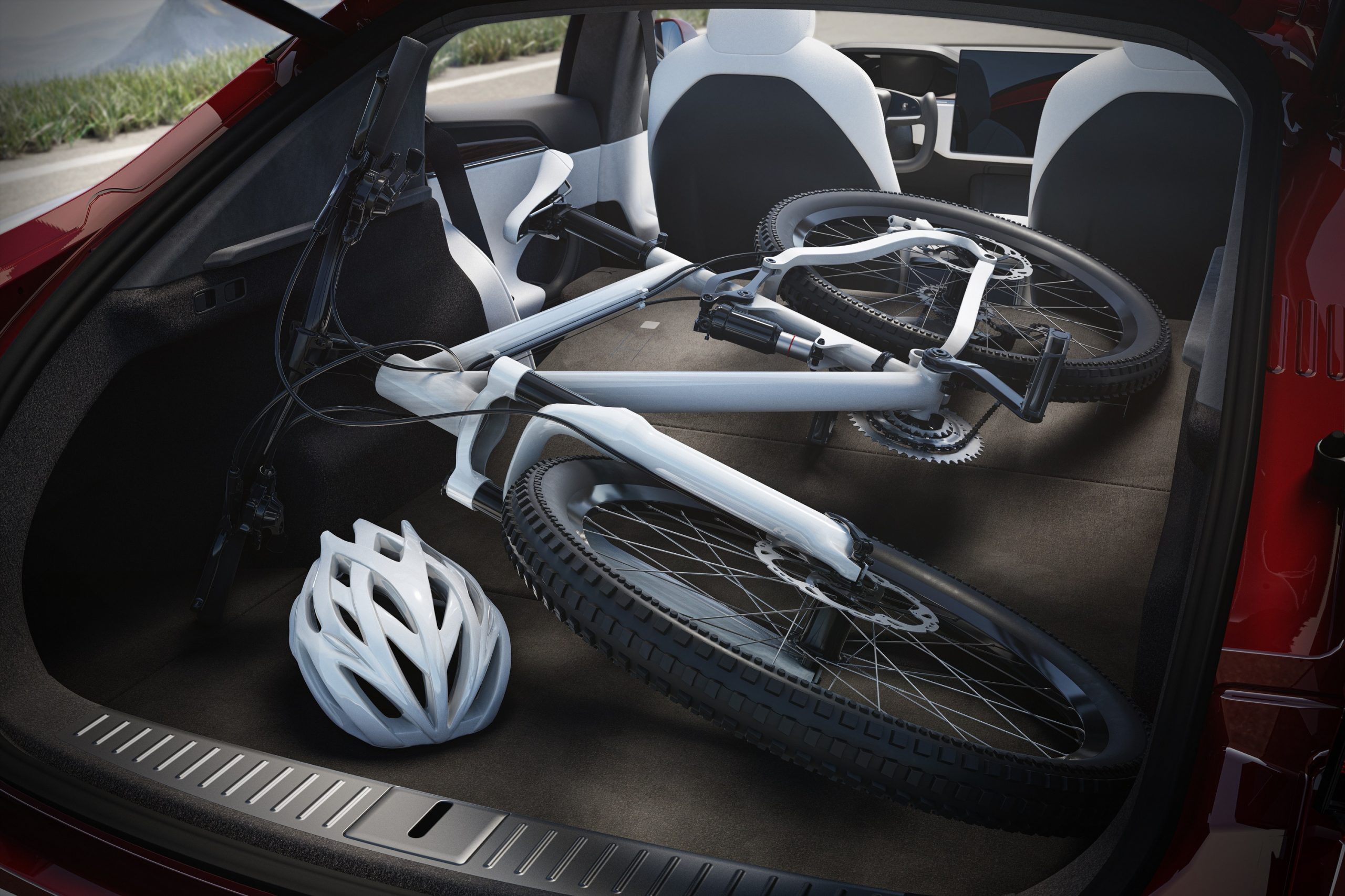 The liftback trunk of a Tesla Model S EV with a bike in it