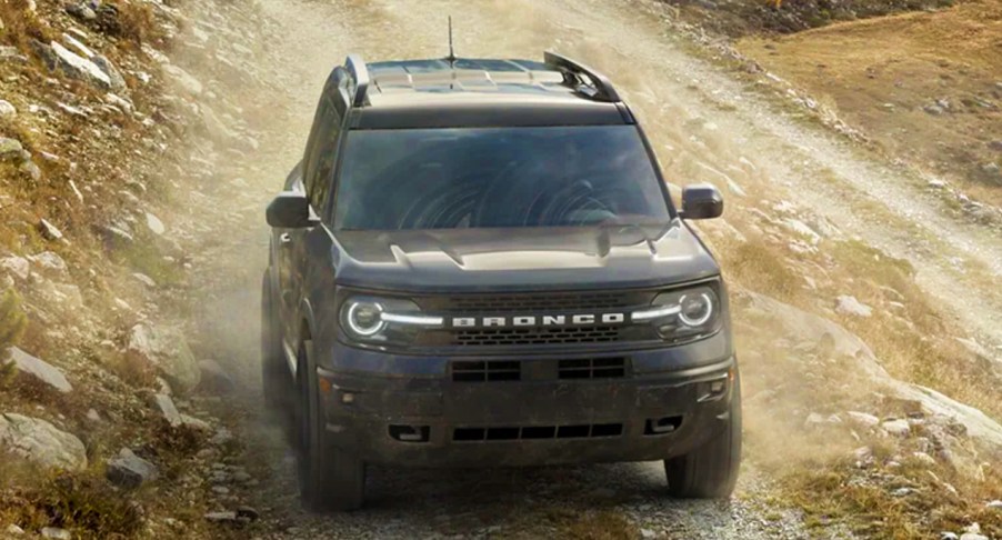 A black 2022 Ford Bronco Sport is driving off-road.