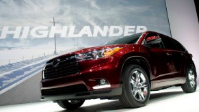 A red Toyota Highlander is on display.