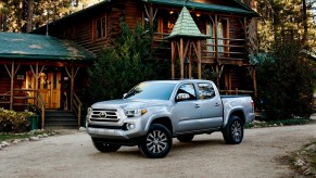 A 2022 Toyota Tacoma parked outside of a house. It is a mid-size truck.