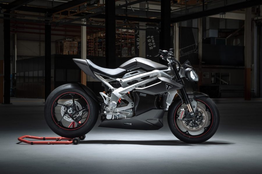 The side view of the Triumph TE-1 prototype on a rear-wheel stand in a garage