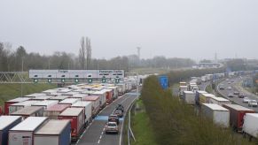 Truckers, some which work for trucking companies, driving down a crowded interstate.