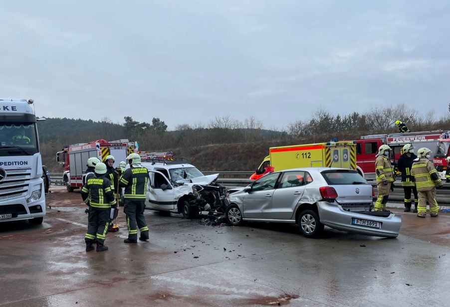 A two car collision on a highway with emergency services on the scenes.