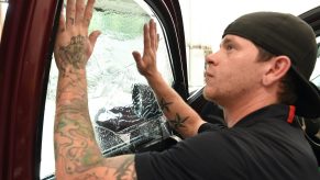 a window tint installer puts tint on a truck