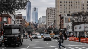 A UPS delivery truck idling in front of the New York City skyline.