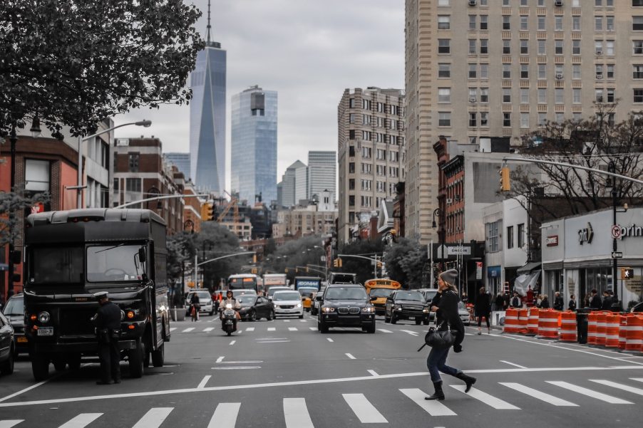 A UPS delivery truck idling in front of the New York City skyline.