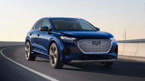 A blue 2022 Audi e-Tron GT driving down a highway.