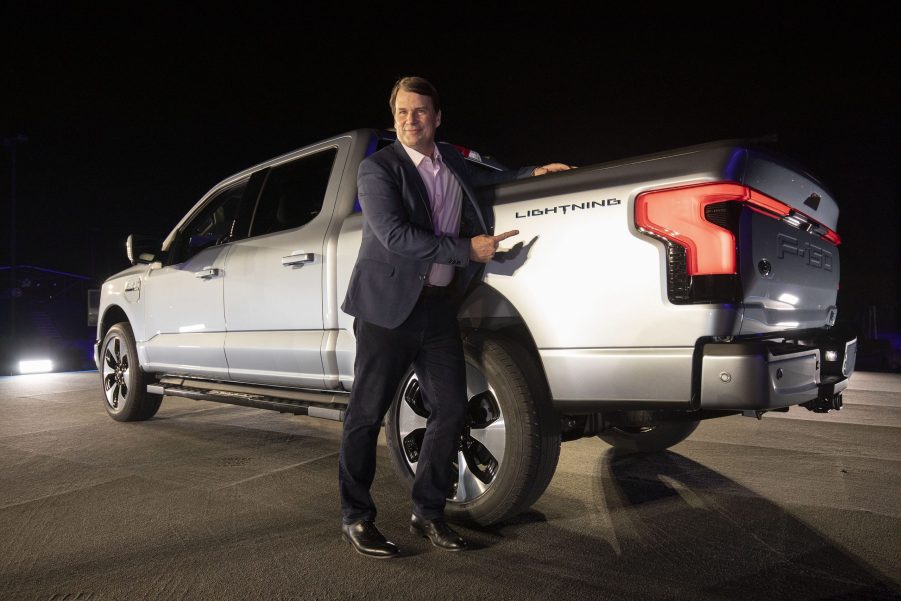 Jim Farley, the CEO of Ford, poses with the F-150 Lightning