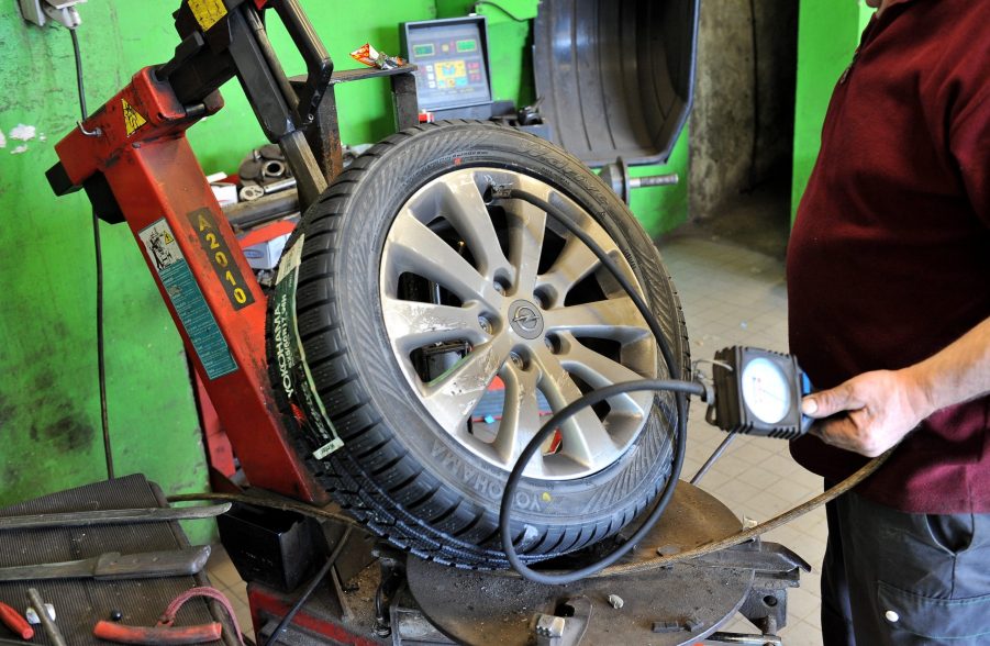 A tech fills up a tire with air