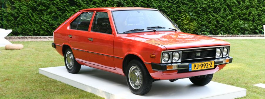 An old bright orange Hyundai.