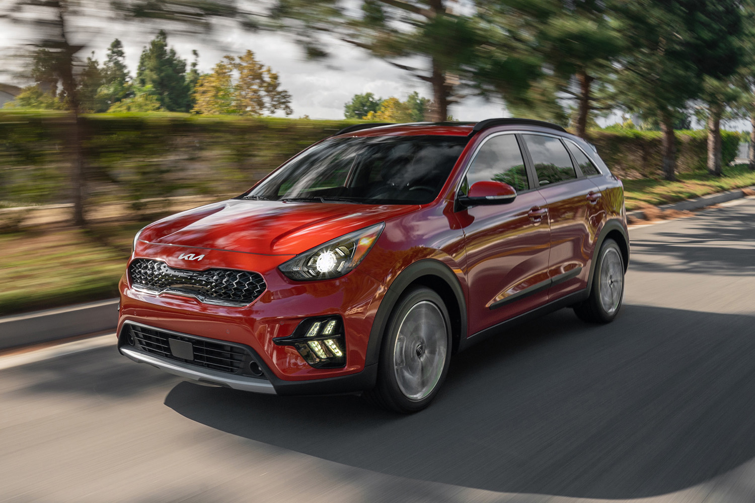 2022 Kia Niro crossover SUV driving down road, front 3/4