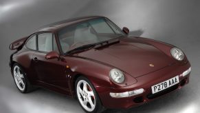 A maroon 1996 993 Porsche 911 Turbo in a studio