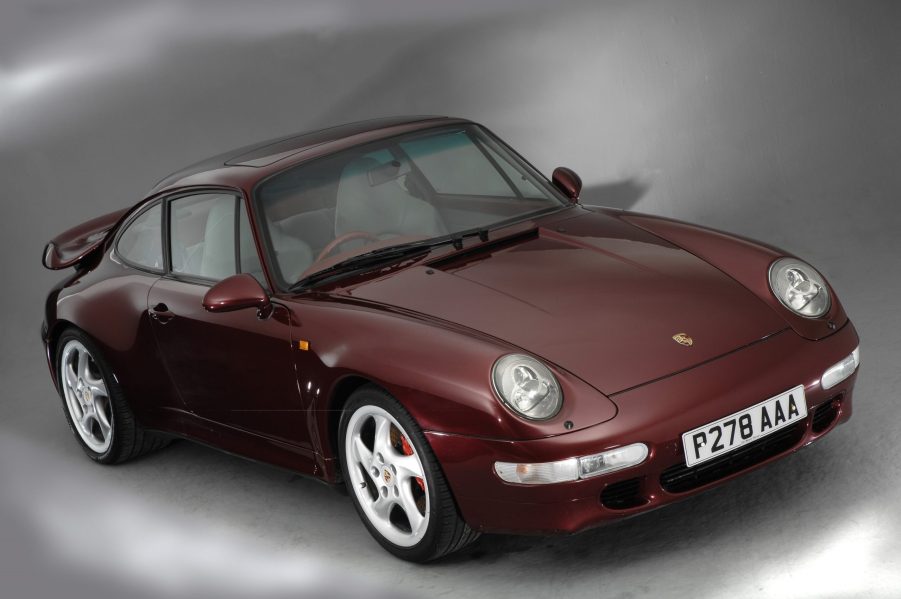 A maroon 1996 993 Porsche 911 Turbo in a studio