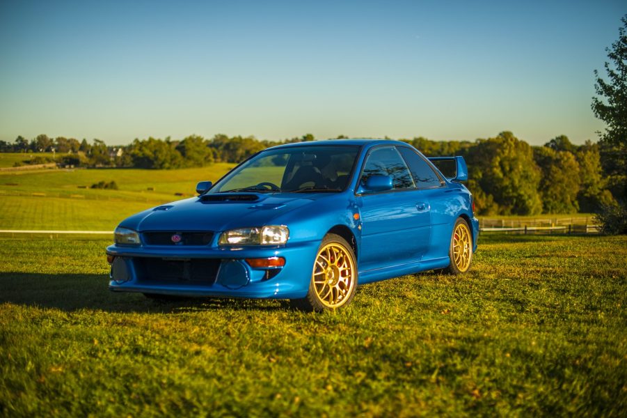 A blue 1998 Subaru Impreza 22B STi in a grassy field