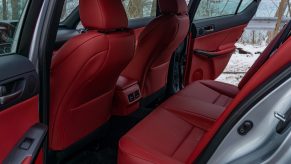 The rear red-and-black seats of a silver 2021 Lexus IS 350 F Sport AWD with Dynamic Handling Package