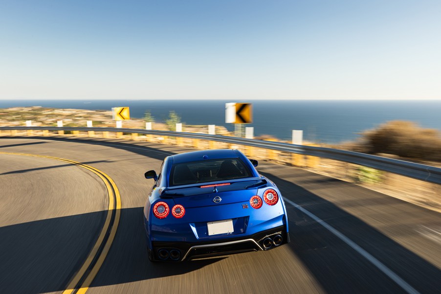 2021 R35 Nissan GT-R driving away from camera on a coastal roadway