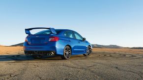 Rear angle view of a blue 2020 Subaru WRX STI