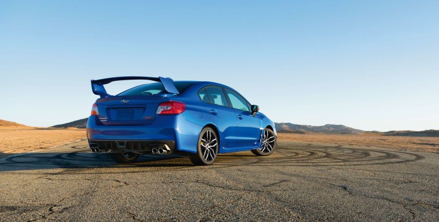 Rear angle view of a blue 2020 Subaru WRX STI