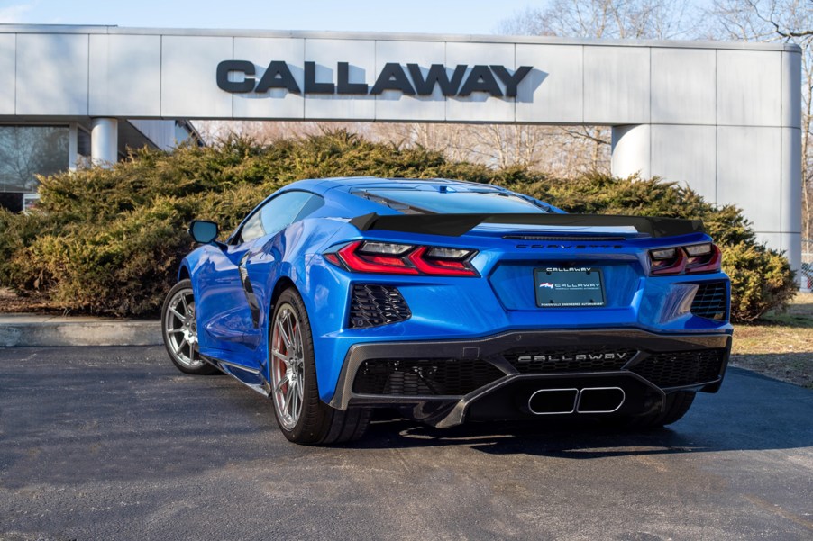 The rear 3/4 view of a blue 2022 C8 Callaway Corvette B2K 35th Anniversary Package in front of the Callaway headquarters